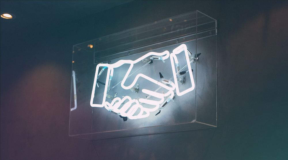 Handshake icon shown neon sign