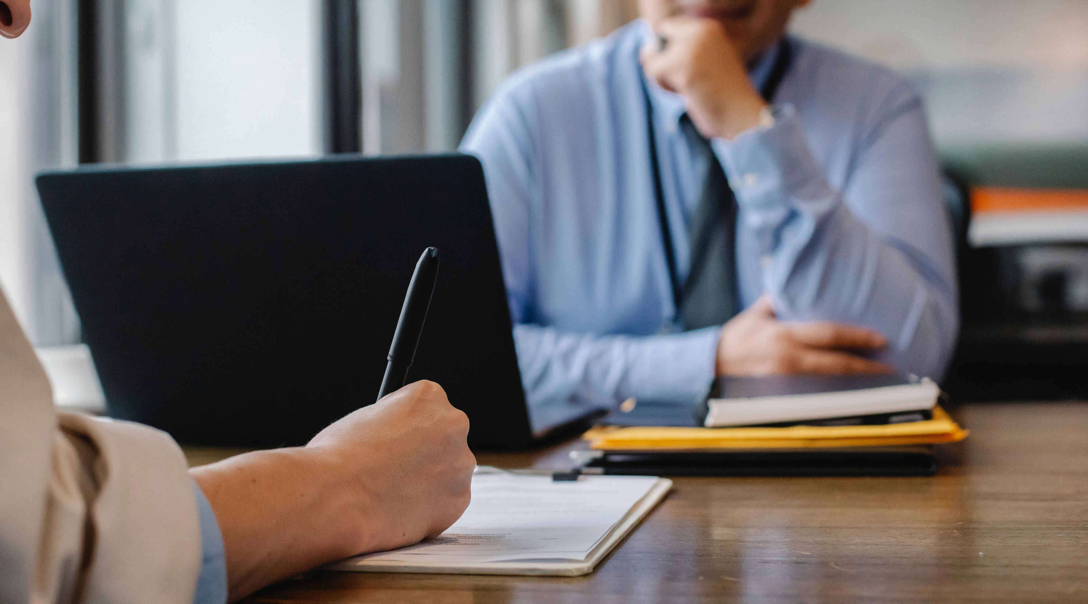 Man being interviewed by a person taking notes