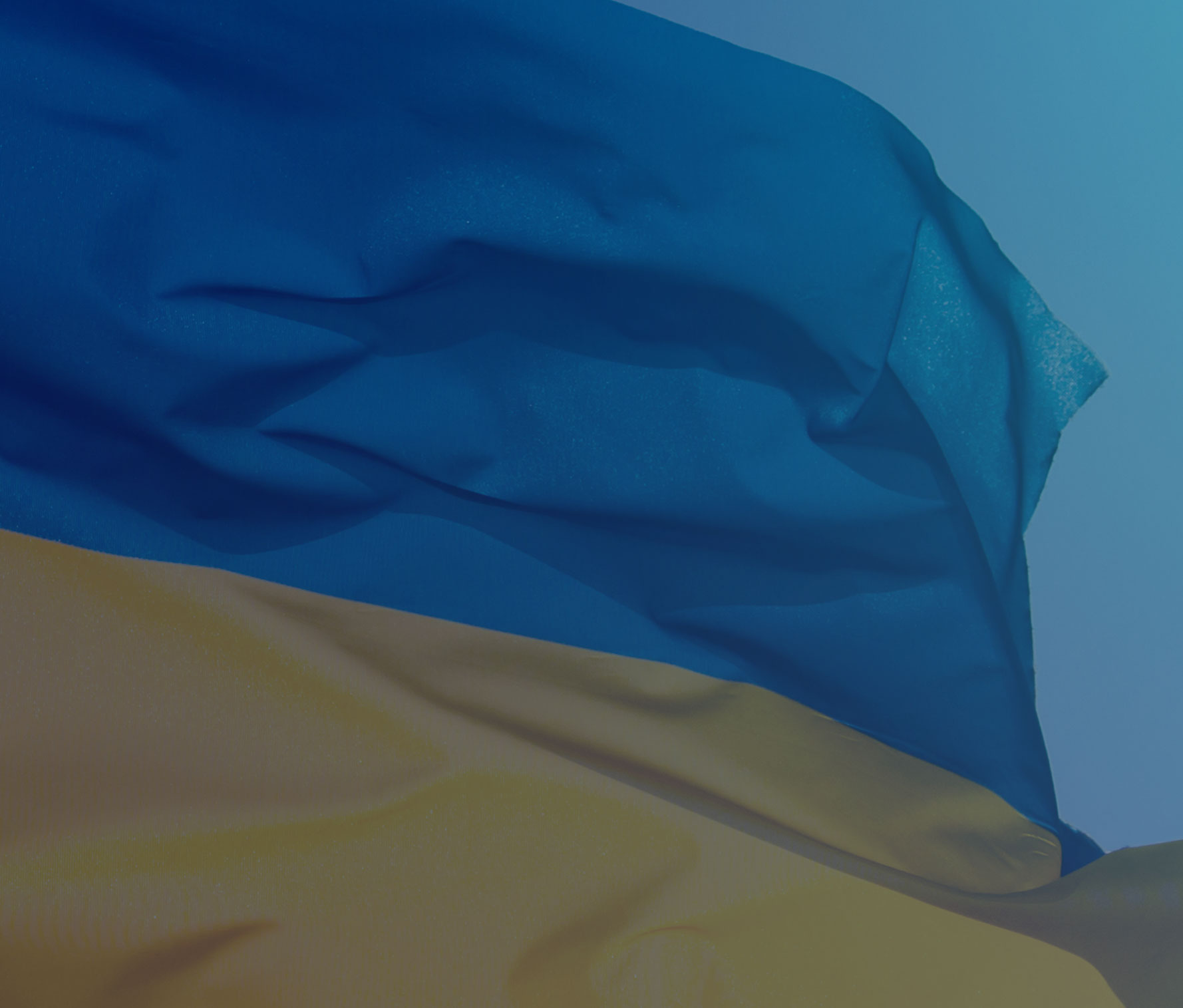 Ukrainian flag blowing in the wind against blue sky