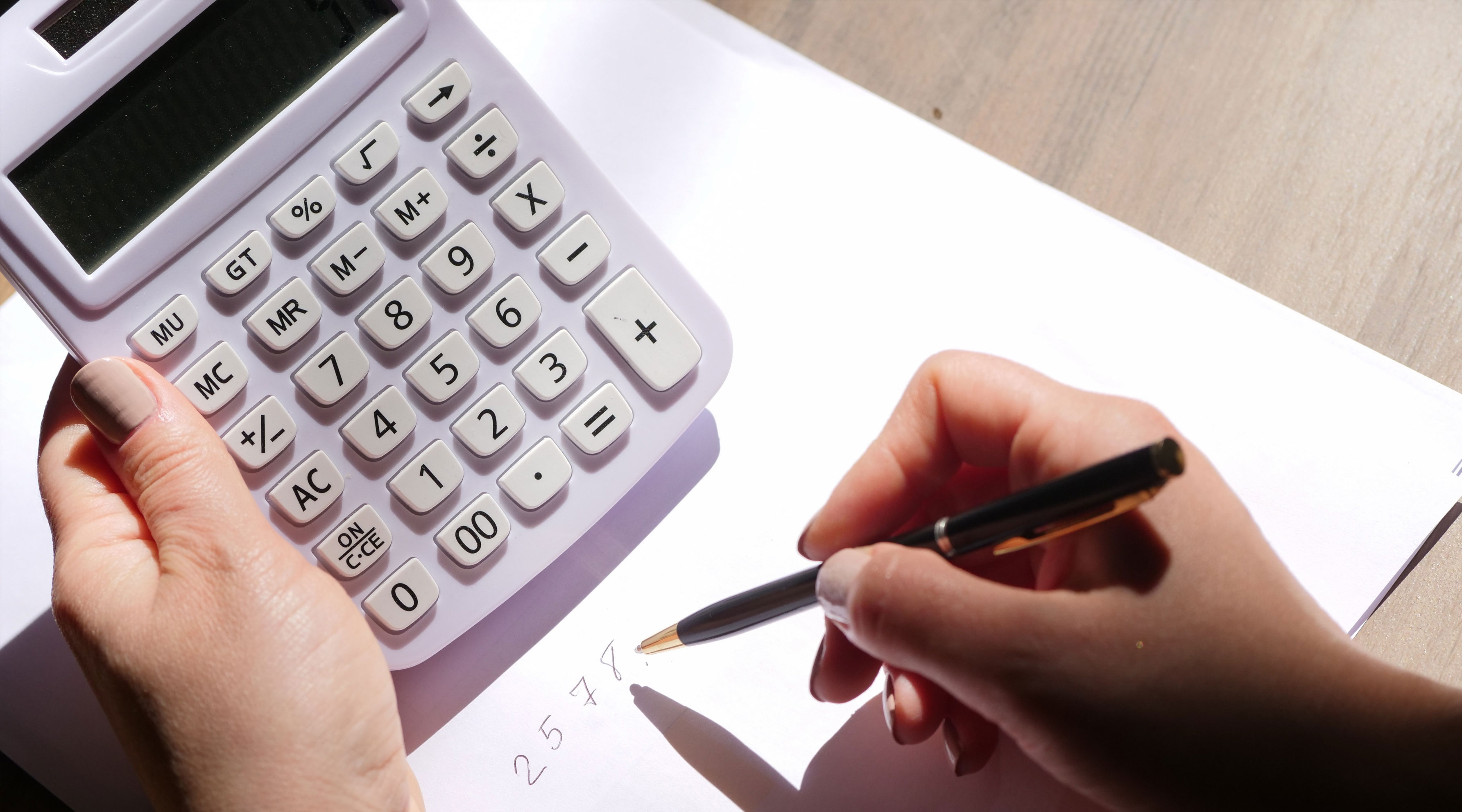 Person doing a math on a calculator