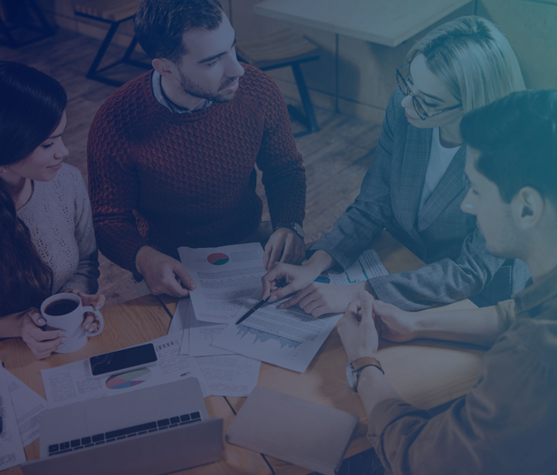 Group of four people around a table having a discussion