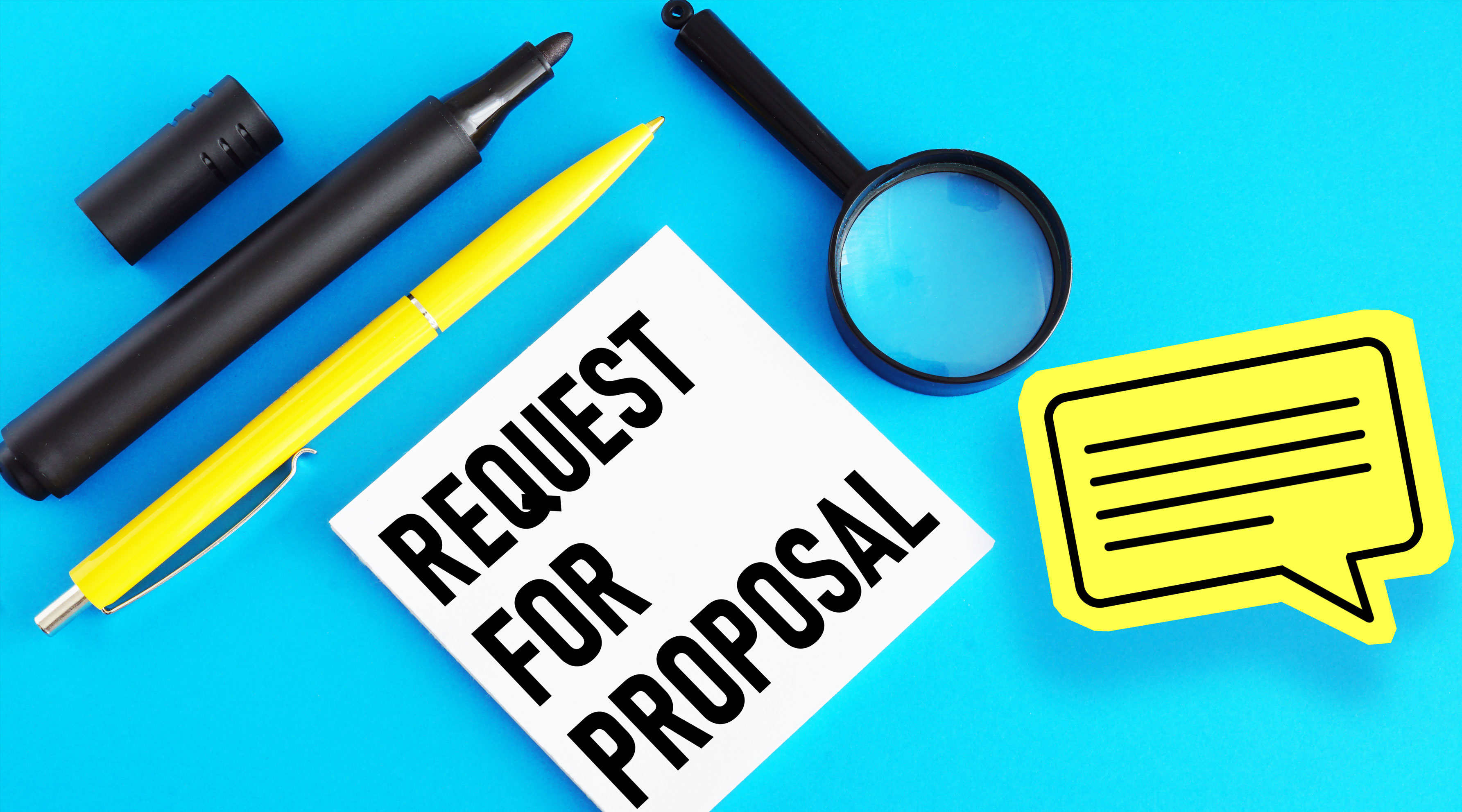 A flat lay image on a bright blue background featuring office supplies and a white card with "REQUEST FOR PROPOSAL" written on it. The items include a black marker, a yellow pen, a magnifying glass, and a yellow speech bubble sticky note.